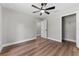 Bedroom featuring wood floors, natural light from the window, walk in closet and a modern ceiling fan at 10033 Canterbury Dr, Leesburg, FL 34788