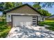 Charming single-story home featuring a two-car garage, well-manicured lawn, and neutral exterior paint at 10033 Canterbury Dr, Leesburg, FL 34788