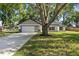 Charming single-Gathering home featuring a modern garage door and well-manicured lawn and landscaping at 10033 Canterbury Dr, Leesburg, FL 34788