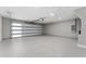 Spacious two-car garage with an epoxy floor and windows on the door at 10033 Canterbury Dr, Leesburg, FL 34788