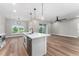 View of the kitchen island, living room, and backyard at 10033 Canterbury Dr, Leesburg, FL 34788