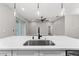 Kitchen island sink view of living room area at 10033 Canterbury Dr, Leesburg, FL 34788