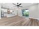 Open-concept living space with modern kitchen and access to the backyard via sliding glass doors at 10033 Canterbury Dr, Leesburg, FL 34788