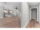 Open-concept living room and kitchen boasts hardwood floors, modern appliances, and a spacious island with breakfast bar at 10033 Canterbury Dr, Leesburg, FL 34788