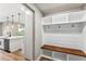 Hallway mudroom boasts custom bench seating, shelving, and storage, in an open-concept layout at 10033 Canterbury Dr, Leesburg, FL 34788