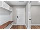 View of the mudroom with a built-in bench and cubbies and coat closet at 10033 Canterbury Dr, Leesburg, FL 34788