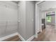 Walk in closet featuring wood floor, wire shelving and gray walls at 10033 Canterbury Dr, Leesburg, FL 34788