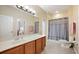 Bathroom featuring a large vanity with a white sink and a large mirror, with a shower and toilet at 105 E Blue Water Edge Dr, Eustis, FL 32736