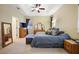 Comfortable bedroom with tray ceilings, carpet, and a full matching furniture set at 105 E Blue Water Edge Dr, Eustis, FL 32736