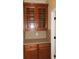 Kitchen hutch with glass front upper cabinets, lower cabinets with granite counters, and diamond tile backsplash at 105 E Blue Water Edge Dr, Eustis, FL 32736