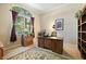 Home office featuring a large window, plush carpet, and built-in shelving at 105 E Blue Water Edge Dr, Eustis, FL 32736