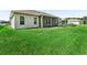 Expansive backyard featuring a well-maintained lawn and screened in porch, perfect for outdoor enjoyment at 10977 Se 169Th Ln, Summerfield, FL 34491