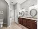 Well-lit bathroom with dual sinks, spacious layout and modern fixtures at 10977 Se 169Th Ln, Summerfield, FL 34491