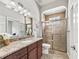 Elegant bathroom featuring a granite countertop vanity and tiled shower at 10977 Se 169Th Ln, Summerfield, FL 34491
