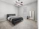 Cozy bedroom featuring a ceiling fan and a comfortable queen-sized bed at 10977 Se 169Th Ln, Summerfield, FL 34491