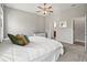 Serene bedroom featuring large windows and a ceiling fan, creating a cozy retreat at 10977 Se 169Th Ln, Summerfield, FL 34491