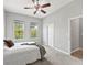 Bright bedroom with carpet, natural light, and access to an ensuite bathroom at 10977 Se 169Th Ln, Summerfield, FL 34491