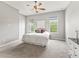 Bright bedroom with large windows, neutral walls and ceiling fan for ultimate comfort at 10977 Se 169Th Ln, Summerfield, FL 34491