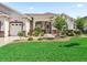 Charming single-story home featuring a well-manicured lawn and beautiful landscaping at 10977 Se 169Th Ln, Summerfield, FL 34491