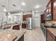 Bright kitchen featuring stainless appliances, granite countertops and convenient layout at 10977 Se 169Th Ln, Summerfield, FL 34491