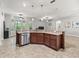 Open kitchen design with stainless steel appliances, granite countertops and ample cabinet storage at 10977 Se 169Th Ln, Summerfield, FL 34491