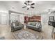 Open concept living room featuring modern furniture, a stylish rug, and adjacent kitchen at 10977 Se 169Th Ln, Summerfield, FL 34491