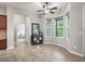 Charming living room with a ceiling fan and large windows, providing ample natural light at 10977 Se 169Th Ln, Summerfield, FL 34491