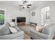Bright living room featuring modern furniture, a stylish rug, and an open concept design at 10977 Se 169Th Ln, Summerfield, FL 34491