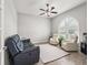 Comfortable living room featuring a ceiling fan, large window, and a modern furniture set at 10977 Se 169Th Ln, Summerfield, FL 34491