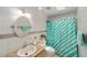 Bright bathroom with a turquoise shower curtain and tiled walls at 1109 Paradise Dr, The Villages, FL 32159