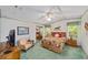 Charming bedroom with floral accents, a ceiling fan, and an abundance of natural light at 1109 Paradise Dr, The Villages, FL 32159