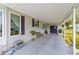 Spacious carport area featuring ample parking and a welcoming entrance to the home at 1109 Paradise Dr, The Villages, FL 32159