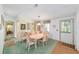 Cozy dining area with a classic table set, complemented by a quaint view into another room at 1109 Paradise Dr, The Villages, FL 32159