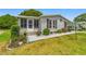Charming single-story home showcasing meticulous landscaping and an inviting exterior at 1109 Paradise Dr, The Villages, FL 32159