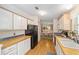 Functional kitchen featuring sleek black appliances, wooden countertops, and ample cabinet space at 1109 Paradise Dr, The Villages, FL 32159