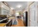 Functional kitchen featuring white cabinetry, updated appliances, and an adjacent dining area at 1109 Paradise Dr, The Villages, FL 32159