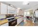 Well-equipped kitchen with white cabinets, modern appliances, and a glimpse into the dining area at 1109 Paradise Dr, The Villages, FL 32159