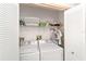 Laundry room featuring side-by-side washer and dryer with shelving and ample storage at 1109 Paradise Dr, The Villages, FL 32159