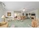 Spacious living room with a fireplace, comfortable seating, and an open layout at 1109 Paradise Dr, The Villages, FL 32159