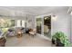 Bright sunroom with sliding glass doors and comfortable seating arrangements at 1109 Paradise Dr, The Villages, FL 32159