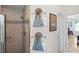 Bathroom boasts tiled shower, shower-head, a grab bar and decorative towels hanging on the wall at 1140 Eureka Mill Run, The Villages, FL 32162