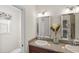 Bathroom with and sinks, decorative vase, and a view that peeks into the toilet area at 1140 Eureka Mill Run, The Villages, FL 32162