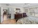 Bedroom featuring a hardwood floor, ceiling fan, and closet that peeks into a nearby sitting and dining area at 1140 Eureka Mill Run, The Villages, FL 32162