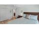 Bedroom featuring a ceiling fan, large closet doors, comfortable pillows, and a view to the bathroom at 1140 Eureka Mill Run, The Villages, FL 32162