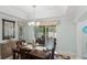 Formal dining room with wood table and chairs and sliding glass doors at 1140 Eureka Mill Run, The Villages, FL 32162