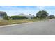 Well-maintained home exterior with lush landscaping along a quiet street at 1140 Eureka Mill Run, The Villages, FL 32162