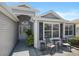 Inviting entryway with decorative door and a cozy seating area on the front porch at 1140 Eureka Mill Run, The Villages, FL 32162