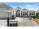 Charming single-story home featuring a cozy front patio and lush landscaping at 1140 Eureka Mill Run, The Villages, FL 32162