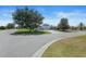 Well-manicured front lawn, mature trees and easy access to Eureka Mill Run and Lucky Hills Drive at 1140 Eureka Mill Run, The Villages, FL 32162