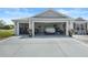 Three-car garage with plenty of storage space, covering for the vehicle and tidy organization at 1140 Eureka Mill Run, The Villages, FL 32162